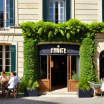 **

> A charming, small hotel in Bordeaux, France, with a newly renovated facade. The exterior features a vertical garden filled with lush greenery. Guests are relaxing in the garden, enjoying drinks. In the background, people are taking photos and smiling, showcasing the hotel's fresh, inviting atmosphere. A sign indicates "Financé par Crowdfunding" (Funded by Crowdfunding). Warm, sunny lighting.

**